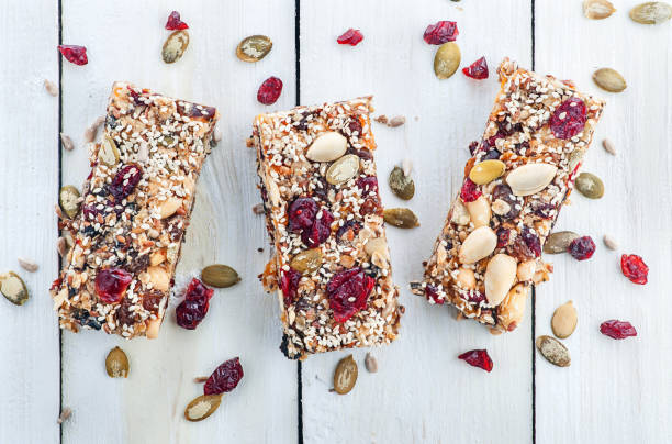 barra de granola en mesa de madera - protein bar cereal oat cranberry fotografías e imágenes de stock