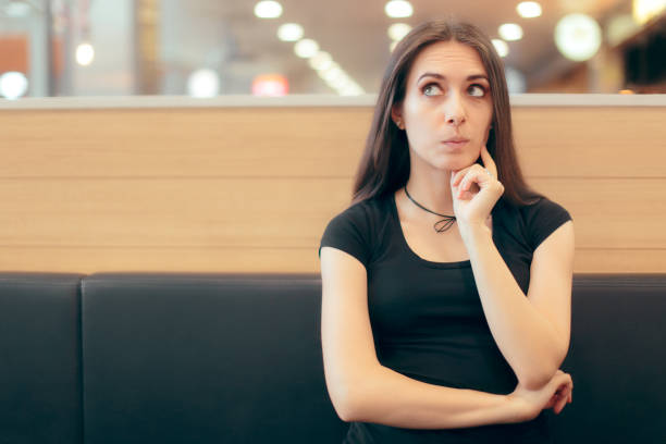 istock Woman Sitting in Fast Food Restaurant Thinking While Waiting 964962794