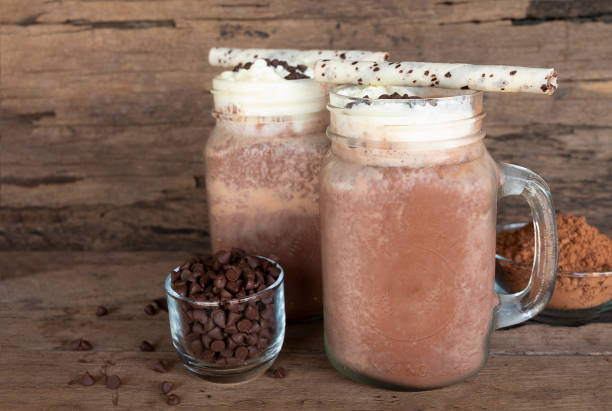 istock Chocolate and cocoa mixed with milk smoothies on wooden floor. 964966566