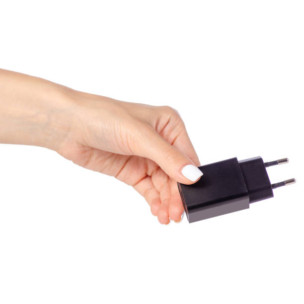 istock Charger for mobile phone in hand 964966934