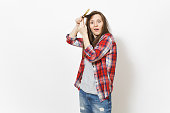 Young crazy loony woman in casual clothes winding hair on paint brush isolated on white background. Instruments, accessories, tool for renovation apartment room. Repair home concept. Advertising area.
