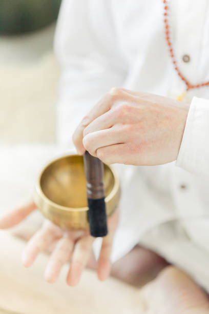 istock Man practicing kundalini yoga and meditation with a singing bowl 964971670
