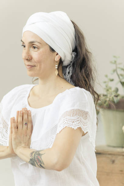 istock Woman practicing kundalini yoga lotus pose and mudra 964971898