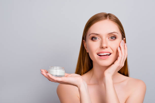 istock Correction wrinkles wax therapy solution pampering clean clear body perfection concept. Close up portrait of cute sweet lovely gorgeous beautiful cheerful girl holding cream isolated gray background 964974532