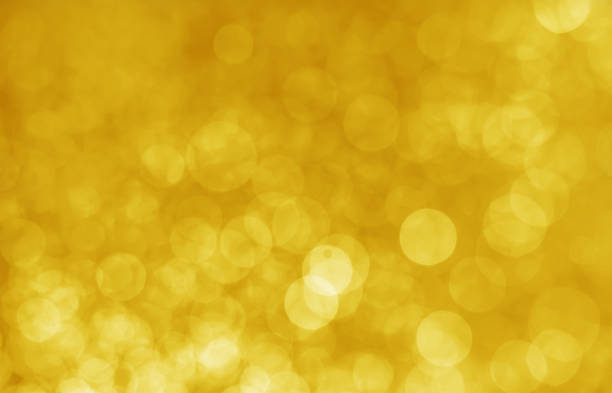 istock abstract yellow bokeh glitter sparkle background. 964981724