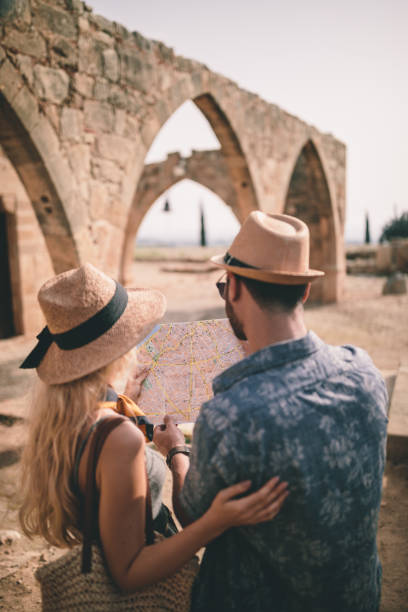 istock Tourists reading map and planning route at ancient Greek church 964985106