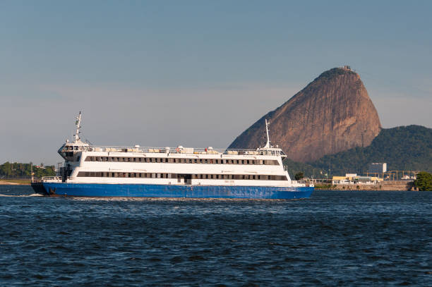 Passenger Ferry Boat Crossing Guanabara Bay With Sugarloaf Mountain in Background in Rio de Janeiro, Brazil.
