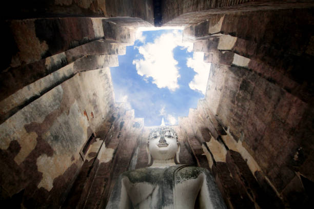 Ancient marvellous stone buddha statue surrounding by great wall and attractive blue sky at Wat Sri Chum, Sukhothai, Thailand, smilling peace buddism location , travel destination backgrounds,