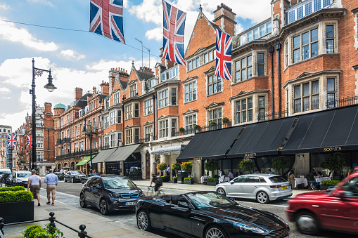 Shops and restaurants on Mount Street London, decorated by British flags