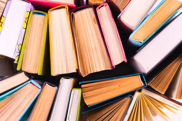 istock Top view of bright colorful hardback books in a circle. 964998656
