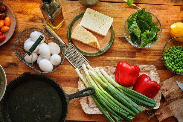 istock Preparing Frittata with Paprika, Spring Onions, Peas, Spinach and Parmesan 965002050