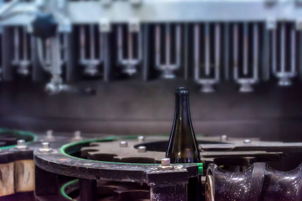 istock Wine bottle on corking conveyor at winery 965002202