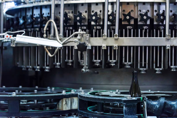 istock Wine bottle on corking conveyor at winery 965002326
