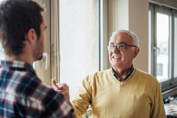 istock Senior father shaking hands with adult son 965002652