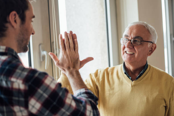 istock Old man giving high-five to a young man 965002830