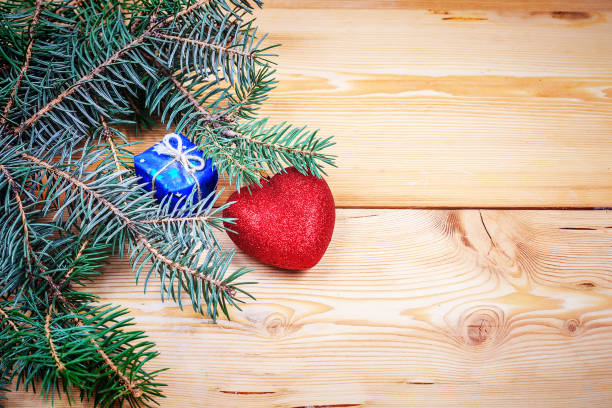 istock christmas tree branch on the wooden background 965007122