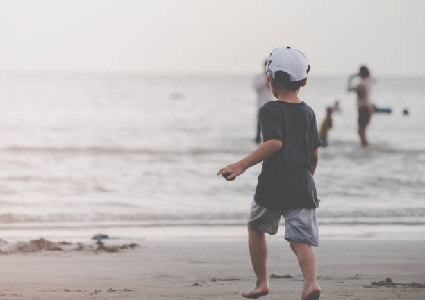 istock Little kid running to a sand beach 965014358