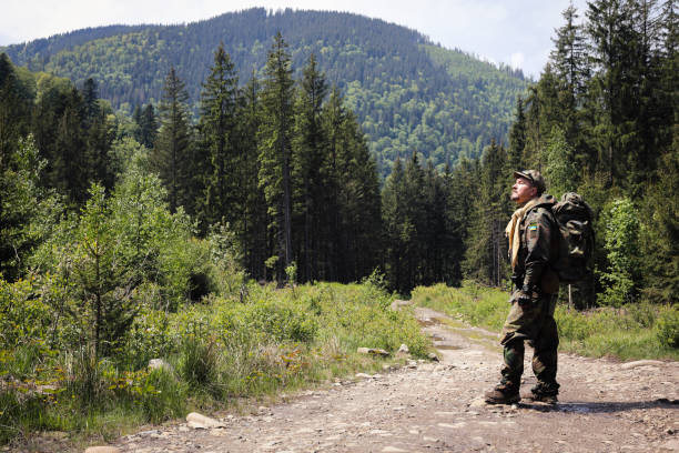 istock Active healthy man hiking in beautiful forest 965020280