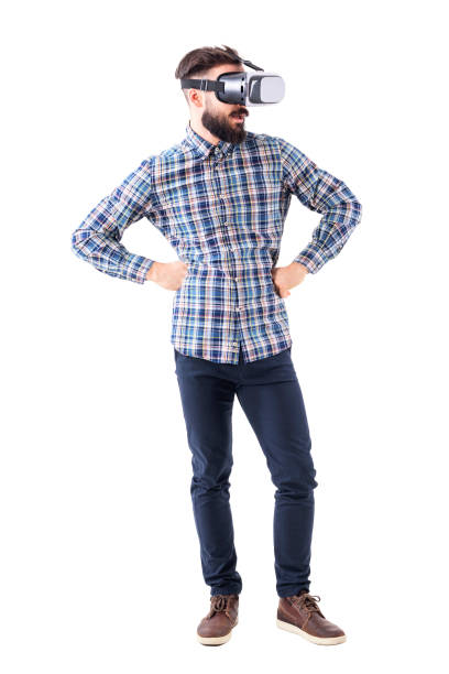 istock Business bearded man with hands on hips watching virtual reality glasses headset. 965020608