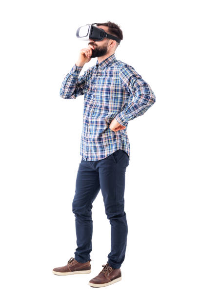 istock Thinking business man with hand on chin watching virtual reality glasses. Side view. 965020840
