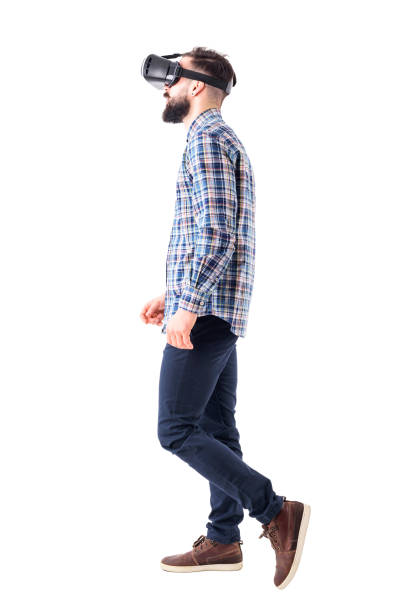 istock Profile view of business man watching virtual reality headset walking. 965020880