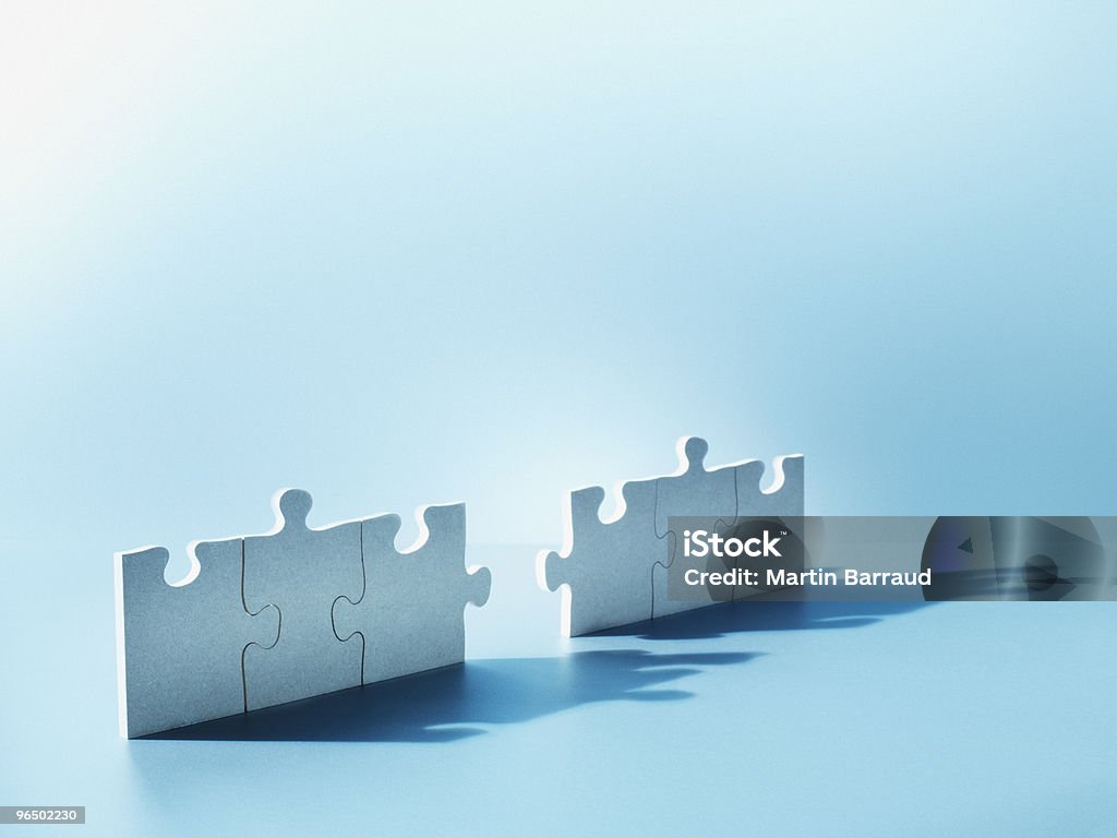 Jigsaw puzzle pieces standing on end  Mergers and Acquisitions Stock Photo
