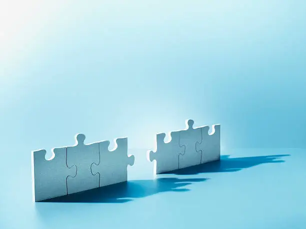 Photo of Jigsaw puzzle pieces standing on end