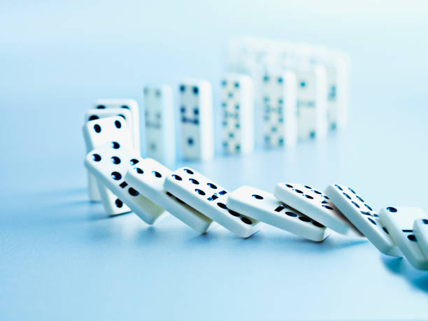 Dominoes falling in a row  domino effect stock pictures, royalty-free photos & images