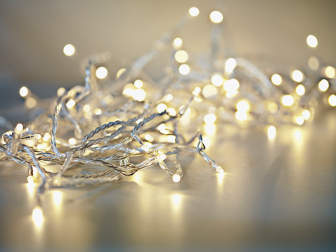 glass ball with snowflakes illuminated by colorful light of christmas garland.