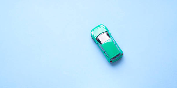 istock Green toy car on abstract blue background 965028592