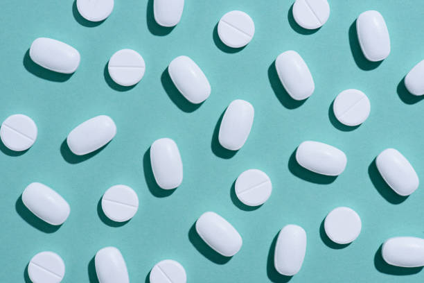 istock top view of white pills on blue surface 965044868