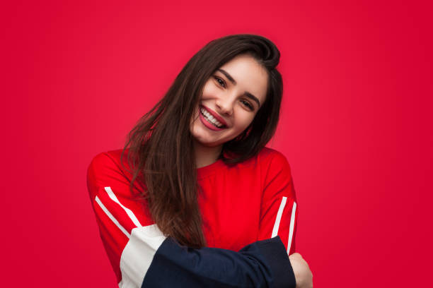 Charming young girl embracing herself