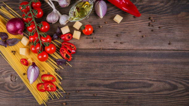 istock Ingredients for cooking spaghetti - raw pasta, tomato, olive oil, spices, herbs 965062476