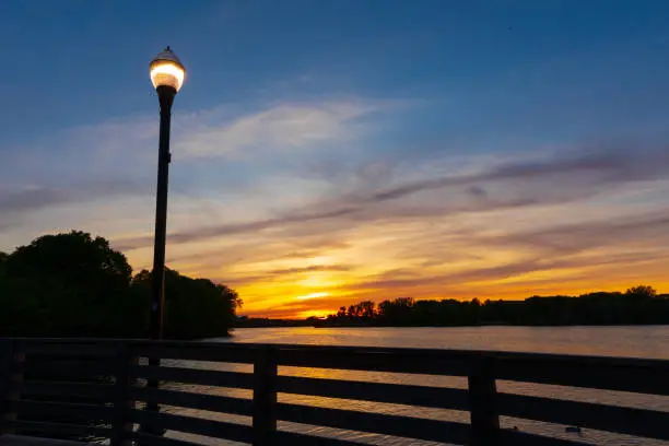 A light turned on at river and beautiful sunset