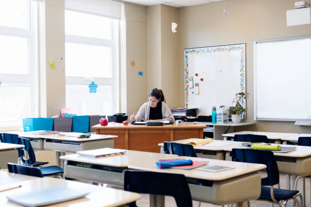 istock Teacher in a Classroom without students at school's out. 965062700