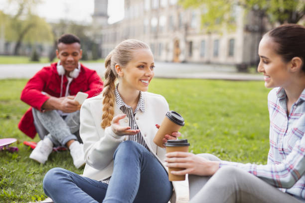 istock Beautiful blonde-haired student smiling communicating with groupmates 965063902