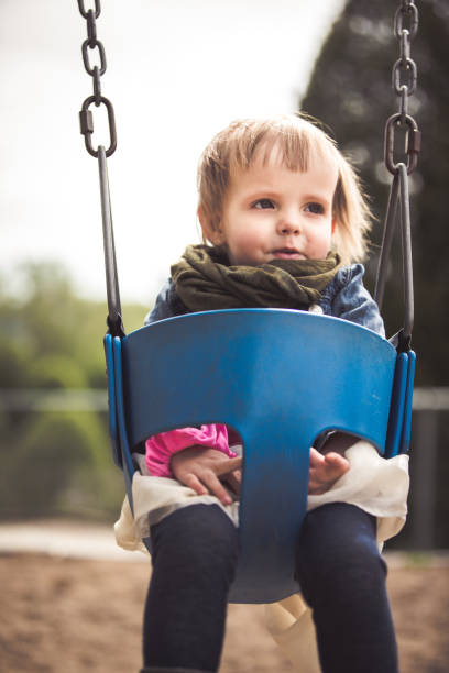 istock Little girl sitting on a swing 965066774