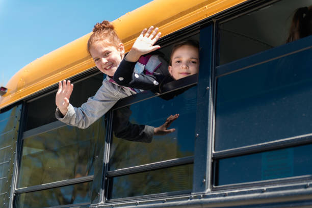 istock Children looking out school bus window 965067378