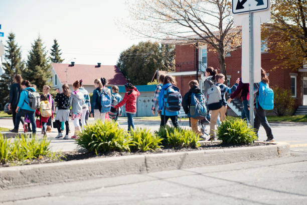 istock Group of elementary school kids getting out a school bus at school's out. 965073010