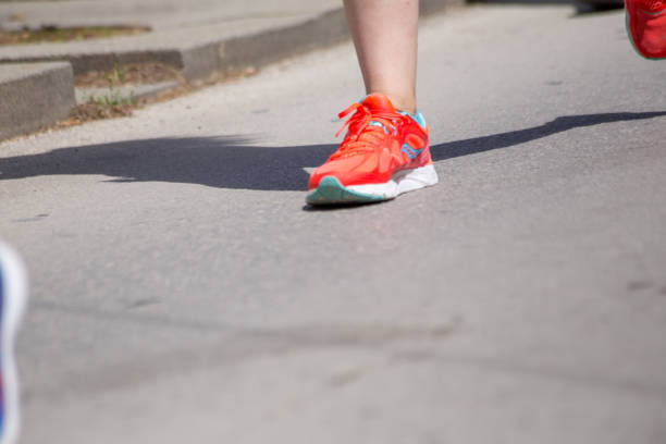 istock runnesr feet back race on asphalt action , background 965073462