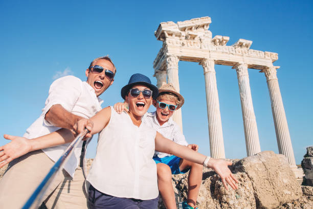 Crazy happy family selfie travel photo on the antique colonnade background. Temple of Apollo,Side,Turkey Crazy happy family selfie travel photo on the antique colonnade background. Temple of Apollo,Side,Turkey temple of apollo antalya province stock pictures, royalty-free photos & images