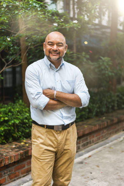 istock Handsome Malay businessman looking at camera in front of workspace 965080286