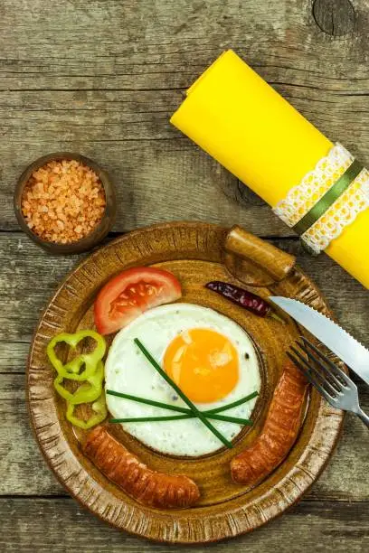 Fried egg for breakfast. Diet food. Food preparation. Fried egg on a wooden table