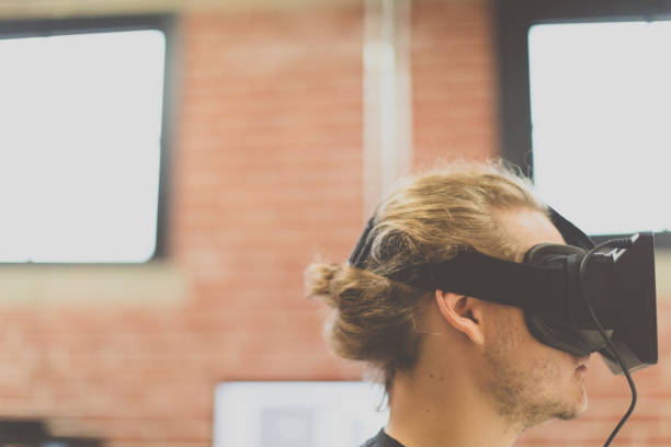 istock Man using virtual reality equipment in a woking place 965089370