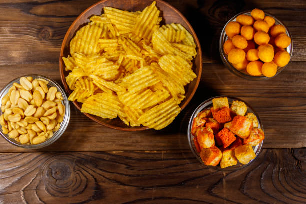 istock Mix of snacks for beer on wooden table 965090056