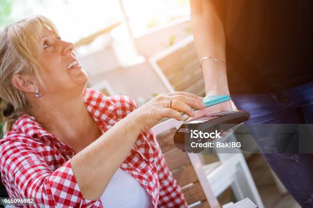Senior Woman Mobile Payment In Cafe Stock Photo - Download Image Now - Contactless Payment, Mature Women, 60-64 Years