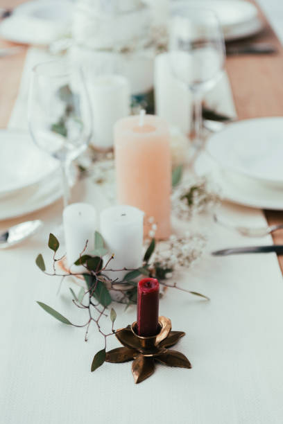 istock close up view of stylish table setting with candles, wineglasses and eucalyptus for rustic wedding 965105560