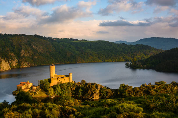 Originally located on a promontory overlooking the Loire gorges, the Grangent castle stands on an island since the building of the Grangent dam in 1957. Saint-Just-Saint-Rambert, France - May 15, 2018: Originally located on a promontory overlooking the Loire gorges, the Grangent castle stands on an island since the building of the Grangent dam in 1957 saint étienne photos stock pictures, royalty-free photos & images