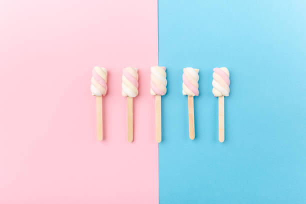 istock Marshmallows on sticks on tender pink background 965120278
