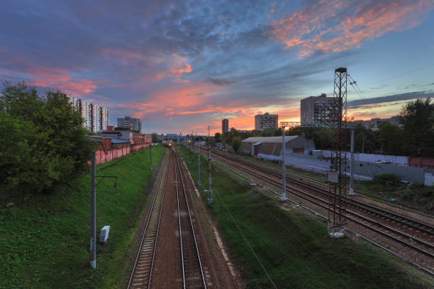 istock View from the bridge on a beautiful sunset and approaching the railroad train 965132250